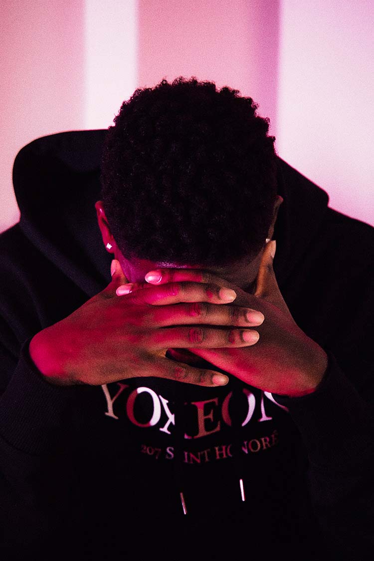 A man holding his face