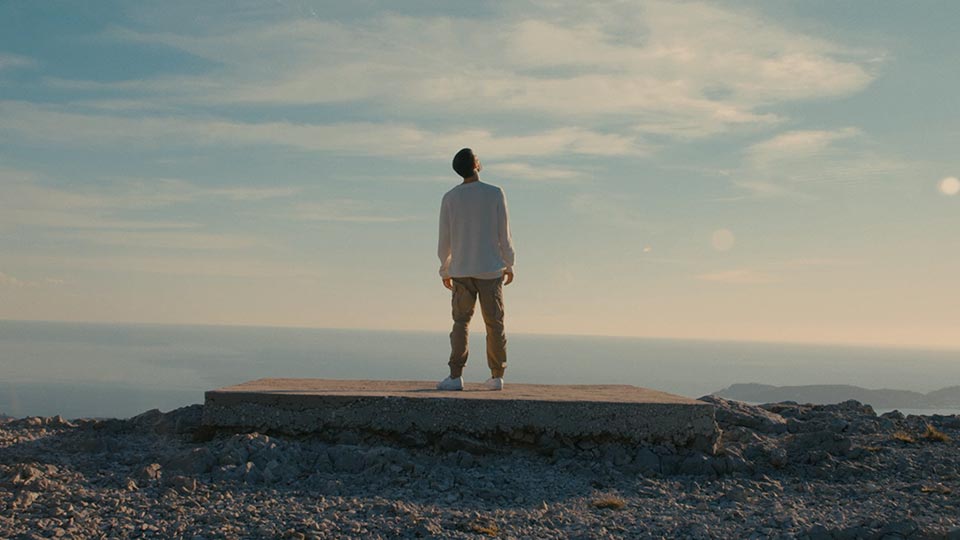 Man standing on edge of cliff